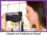 Woman operating handheld personal digital camera (Staged with Professional Model).